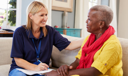 a caregiver having converstation with a senior woman